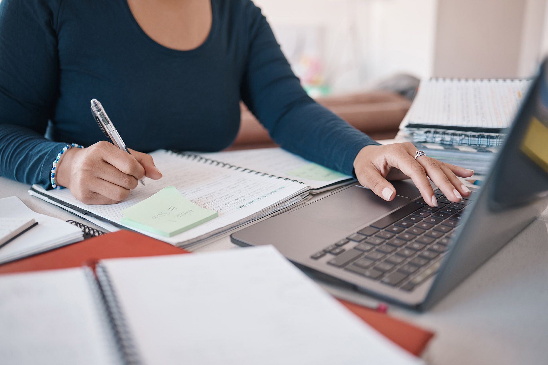 notebook-laptop-and-writing-hands-of-black-woman-o-ZDYYSGP